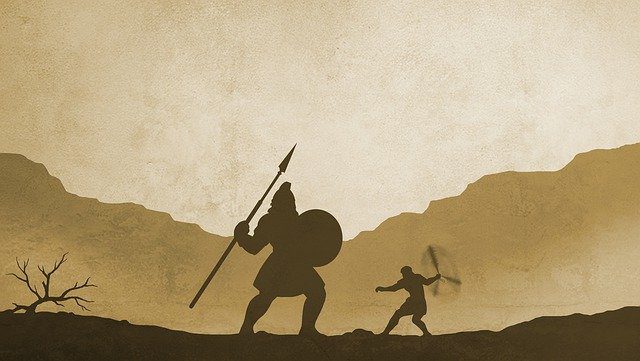 A man and woman are fighting in the desert.