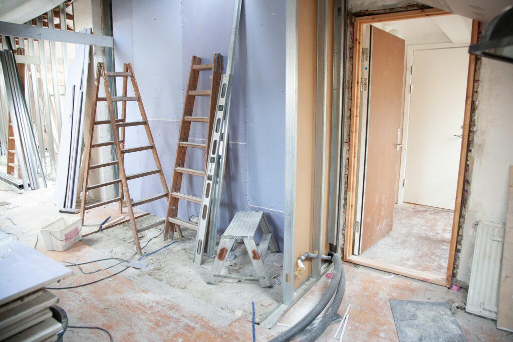 A room being remodeled with ladders and scaffolding.