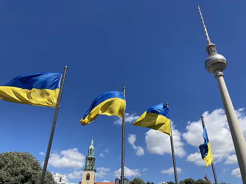 A group of flags flying in the wind.