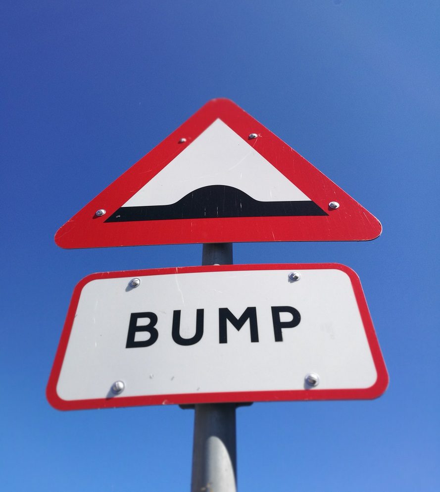 A bump sign is shown on the side of a road.