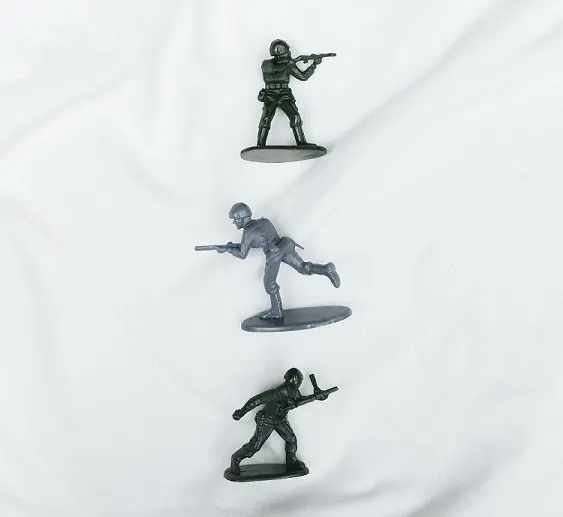 Three toy soldiers are shown on a sheet.