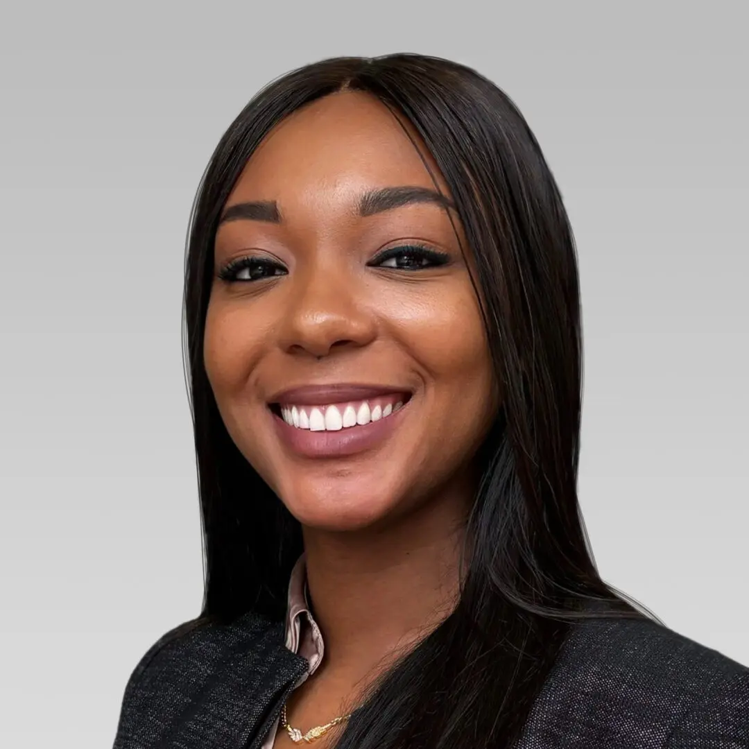 Professional woman smiling confidently in business attire.